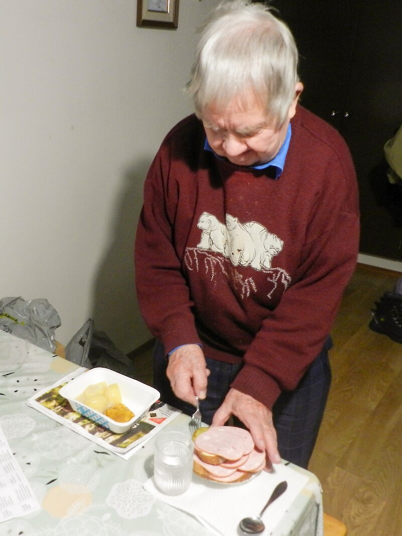 Vanha mies valmistaa ateriaansa